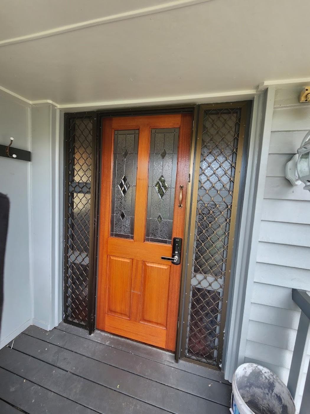 A restored timber front door with leadlight glass panels